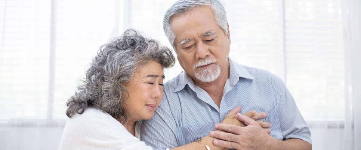 Asian wife embrace senior husband after receive diagnosis of sickness